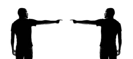 Silhouettes of two men blamng each other for not being accountable. Silhouettes of two men holding each other responsible for church accountability.